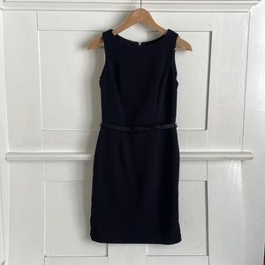 Belted black cocktail dress with silver lace details on back